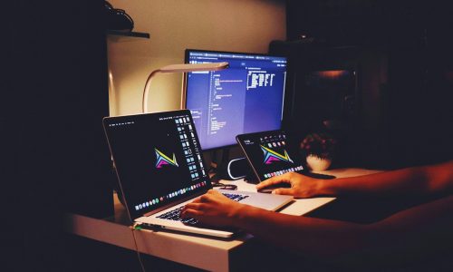 woman in black tank top sitting in front of computer