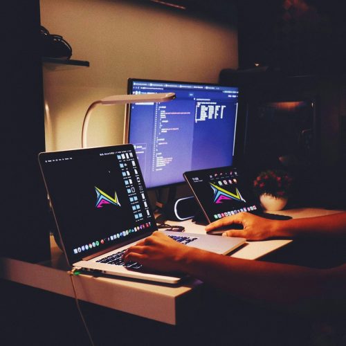 woman in black tank top sitting in front of computer